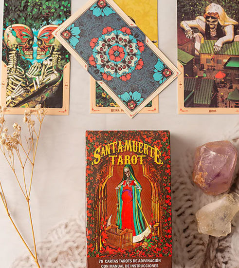 Santa Muerte Tarot Deck in Spanish featuring mystical illustrations inspired by Day of the Dead traditions and ancestral symbolism.