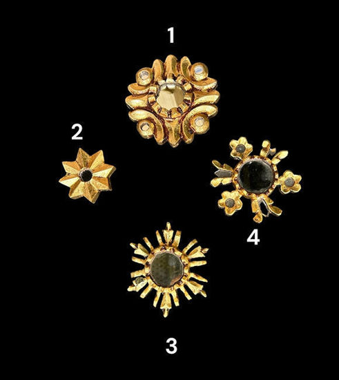 Four gold sun-shaped mirrors displayed against a black background, showcasing intricate designs and vintage elegance.