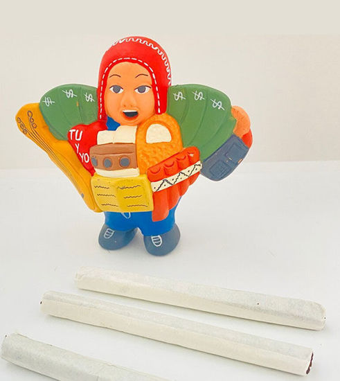 Handmade Ekeko doll, 4x8 inches, depicting a man with a cigarette and pipe, symbolizing abundance and good luck in Andean culture.