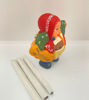 4x8-inch Ekeko doll, a ceramic figure of a man holding a cigarette and pipe, representing prosperity and positive energy in Andean mythology.