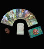 A deck of Green Witch Tarot cards, an illustrated guidebook in Spanish, and a shell displayed on a table, suggesting meditation.