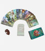 A Spanish edition of the Green Witch Tarot deck, its guidebook, and a shell on a table, symbolizing connection to nature's wisdom.