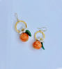 Picture of hand painted ceramic orange earrings with ceramic flower and leaf pendants