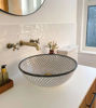 Elegant black and white Moroccan ceramic sink featuring unique patterns, perfect for enhancing any bathroom countertop.