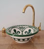 Elegant green and gold bowl sink featuring a gold faucet, highlighting unique Moroccan craftsmanship and modern design.