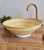 Unique beige ceramic wash basin with gold and white design, reflecting traditional Moroccan artistry in a mid-century modern style.