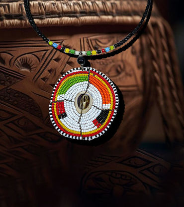 Multicolored Maasai beaded necklace featuring a circular design and a cowrie shell centerpiece, showcasing vibrant tribal craftsmanship.