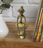 Brass figurine of a tribal woman grinding spices, skillfully handcrafted in Dhokra art, reflecting traditional Indian culture.