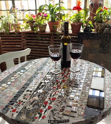 Picture of Round Mosaic tabletop with everyday items cemented in; original round bistro tabletop