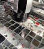 Picture of Round Mosaic tabletop with everyday items cemented in; original round bistro tabletop