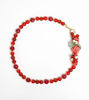 Red beaded bracelet featuring a charming pomegranate pendant, showcasing a playful and vibrant accessory for any outfit.