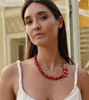 Playful red beaded bracelet with a pomegranate charm, ideal for adding a pop of color and whimsy to your accessory lineup.