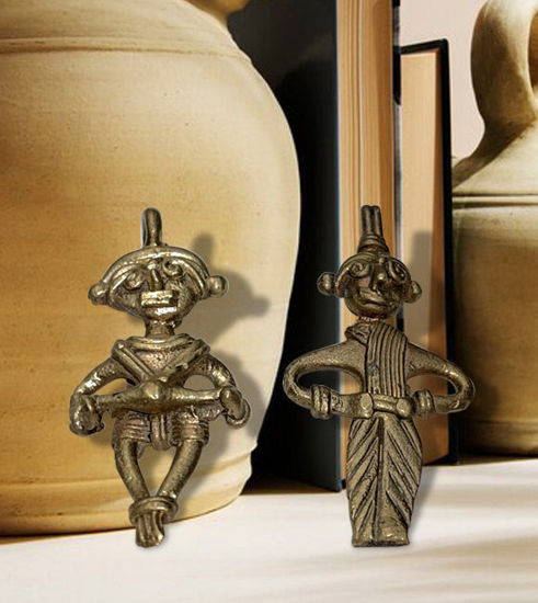 Two handmade brass figurines of a tribal couple, showcasing intricate Dhokra art and cultural heritage.