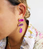 A woman adorned with purple amethyst gum drop earrings, featuring a gold-plated brass setting and unique gemstone textures.