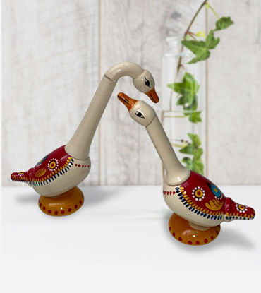 Two ceramic ducks with red and white designs, showcasing intricate patterns and a charming, decorative appeal.