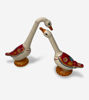 Two decorative ceramic ducks featuring vibrant red and white designs, perfect for enhancing any living space.