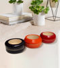 Three small wooden candle holders arranged on a white rug, showcasing their elegant design and craftsmanship.