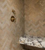 Elegant marble bench in a bathroom, surrounded by honey beige moroccan zellige tiles, creating a cozy and inviting atmosphere.