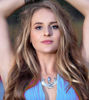 A woman highlighting the Premium Isis Necklace with Moonstone, a symbol of personal growth.