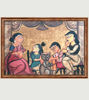 Colorful folk art painting depicting a family gathering at a table, showcasing Indian village life.