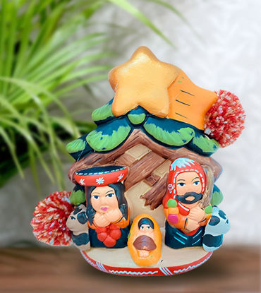 Handmade terracotta nativity scene ornament featuring the Holy Family, topped with a star, showcasing intricate details.
