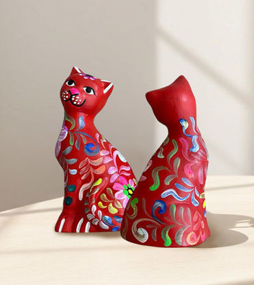 Two handmade Peruvian ceramic cats in vibrant colors sitting on a table, showcasing traditional folk art design.