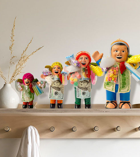 Group of handcrafted Ekeko dolls in diverse outfits, representing prosperity and good fortune, made by Peruvian artisans.