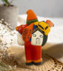 Ekeko Doll figurine of a man with a guitar and bag, representing the Tiwanakan god of abundance from Peru.