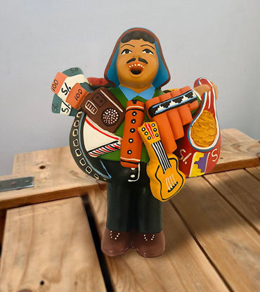 Ekeko doll figurine of a man with a musical instrument, representing the Tiwanakan god of abundance from Peru.