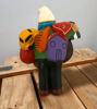 Handcrafted 8" Ekeko doll figurine of a man holding a musical instrument, symbolizing prosperity and good fortune from Peru.