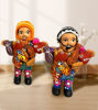 Two vibrant Ekeko doll figurines, each symbolizing prosperity and handcrafted by Peruvian artisans, showcasing cultural heritage.