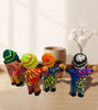 Colorful Ekeko dolls, embodying abundance and good fortune, handcrafted in Peru with unique designs.