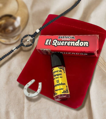 A bottle of El Querendon spiritual oil beside a horseshoe, symbolizing love, protection, and positive energy.