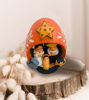 Hand-painted gourd nativity scene ornament with intricate carvings and a star on top, showcasing Andean cultural artistry.