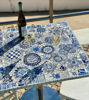 Blue and white floral mosaic tabletop with wine glasses, showcasing handcrafted Portuguese tile art for indoor or outdoor use.