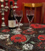 A striking red floral mosaic table, handcrafted with gold accents for a luxurious touch.