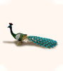 Decorative peacock trinket box featuring a colorful, rhinestone-studded tail on a white background, ideal for storing small items.