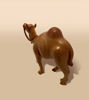 Handcrafted wooden camel statue with a natural finish and rope detail, suitable for rustic and travel-themed interiors.