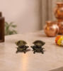 Set of two bronze tortoise diyas on a white surface, featuring detailed designs for traditional spiritual use.